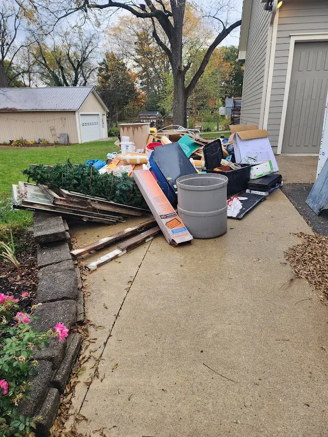 Dumpster being loaded with debris for 12 Yard Dumpster Rental in Eunice